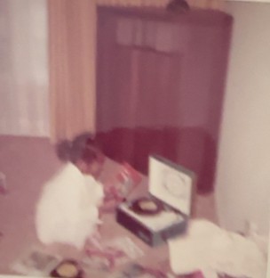 Stephanie Harris as a young girl beside her first record player and her father’s JBL Hartsfield speaker